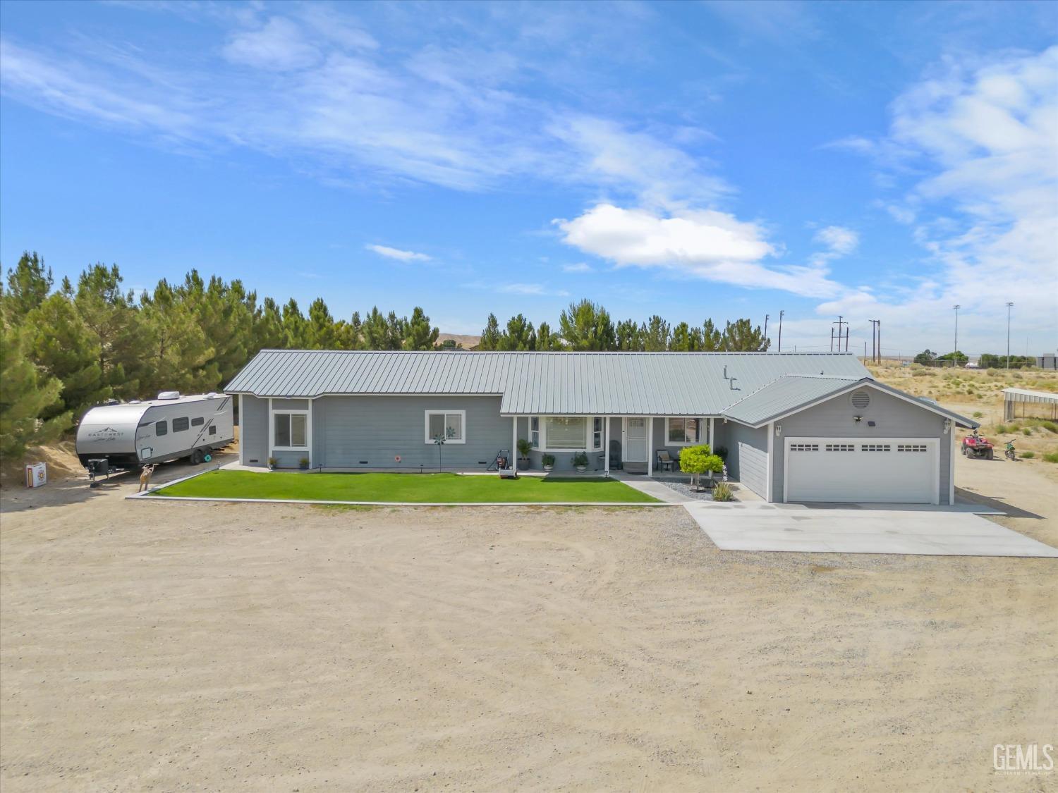 Undisclosed Address Maricopa, CA 93252 - Photo 3 of 47 a front view of house with yard and trees