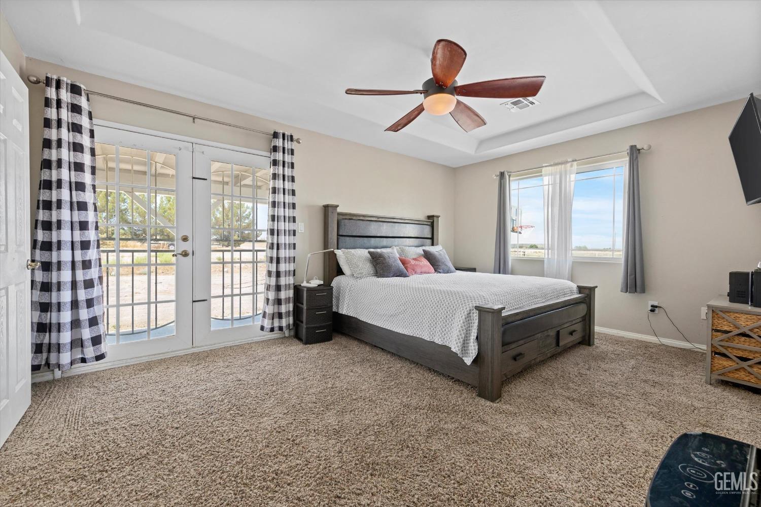 Undisclosed Address Maricopa, CA 93252 - Photo 34 of 47 a bedroom with a bed a ceiling fan and a large window