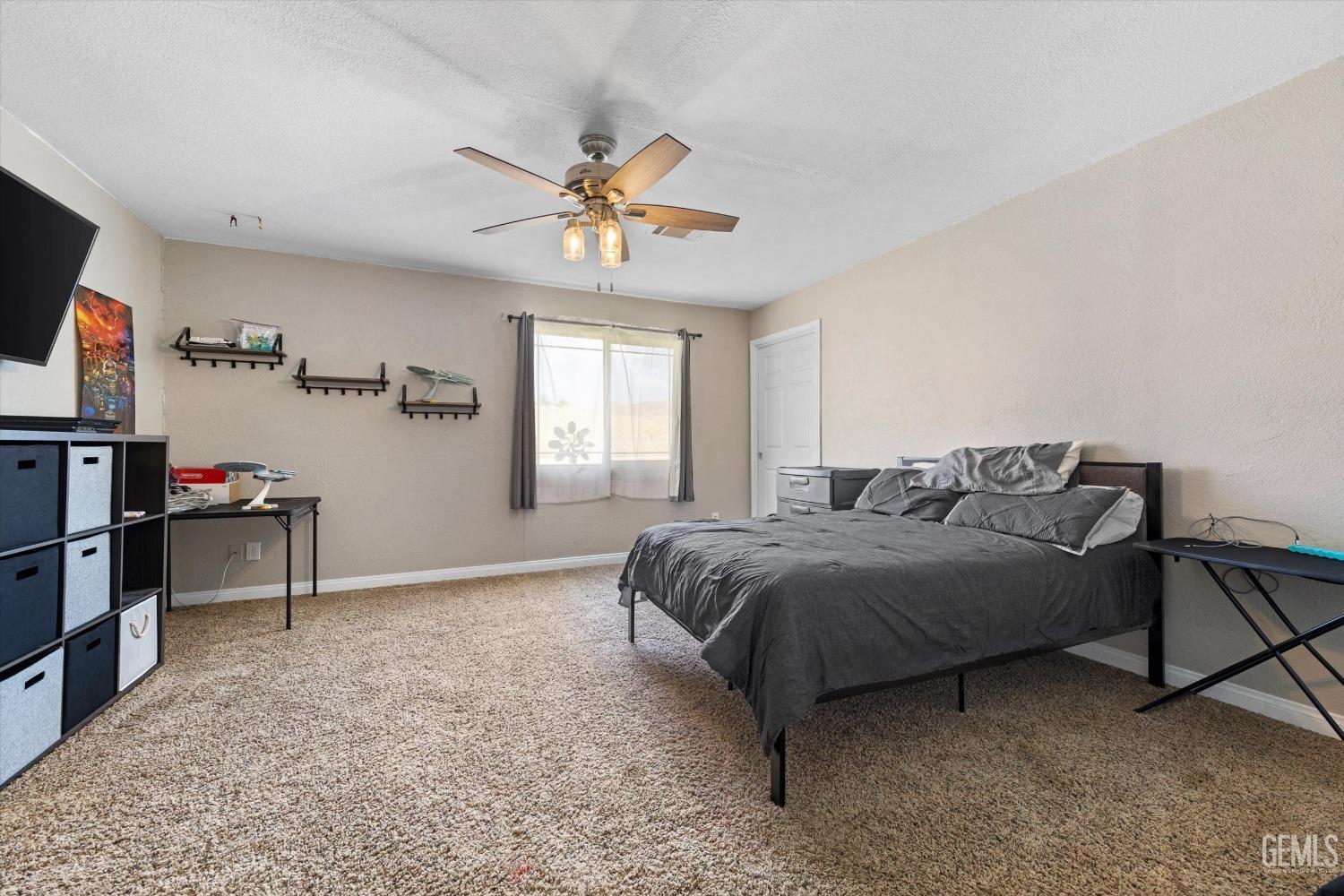 Undisclosed Address Maricopa, CA 93252 - Photo 38 of 47 a spacious bedroom with a bed and a flat screen tv