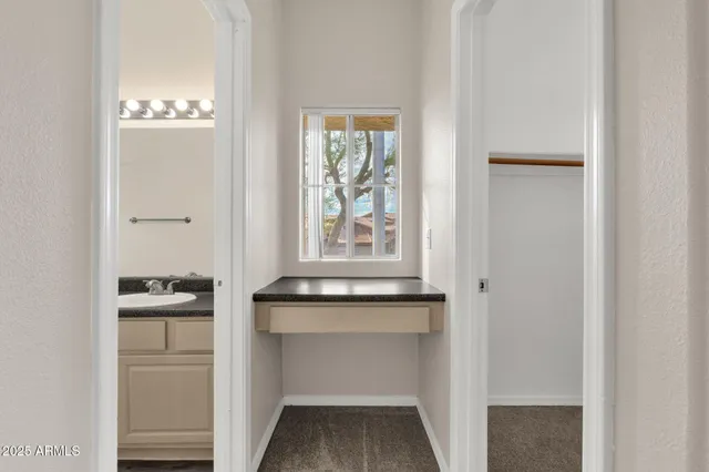 a view of a small house with wooden fence