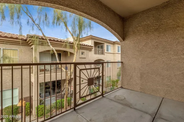 a view of a balcony with outdoor seating