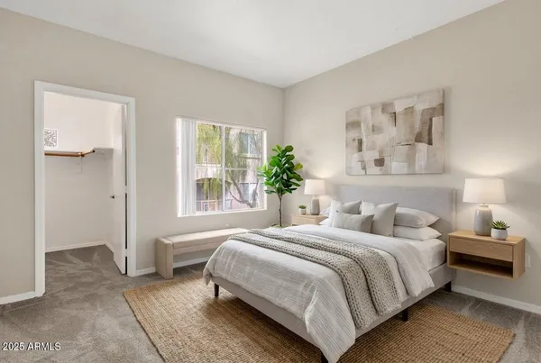 a bedroom with a bed and a window
