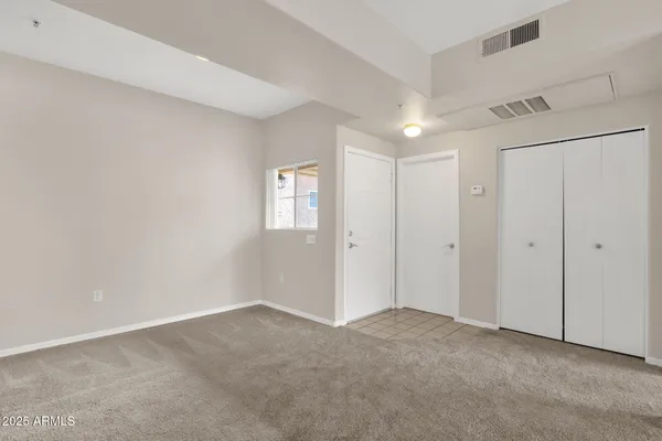 a view of an empty room and a window