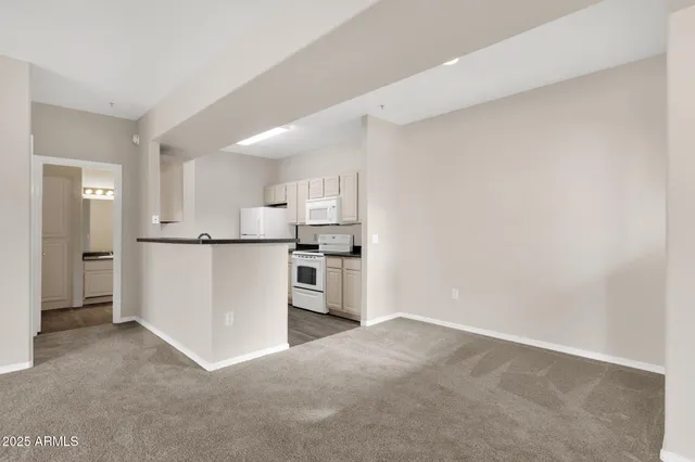 a kitchen with white cabinets and white appliances