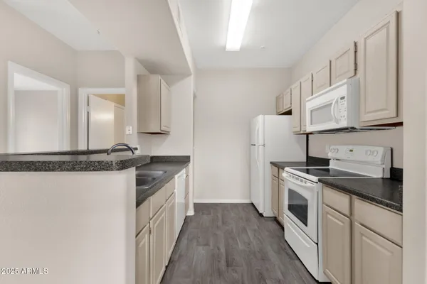 a kitchen with a stove top oven sink and refrigerator