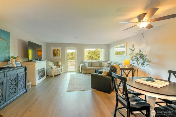 a living room with furniture a dining table and a window