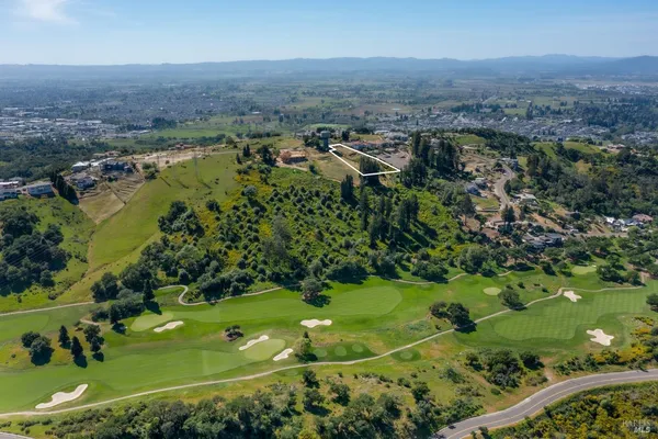 an aerial view of a houses with a yard