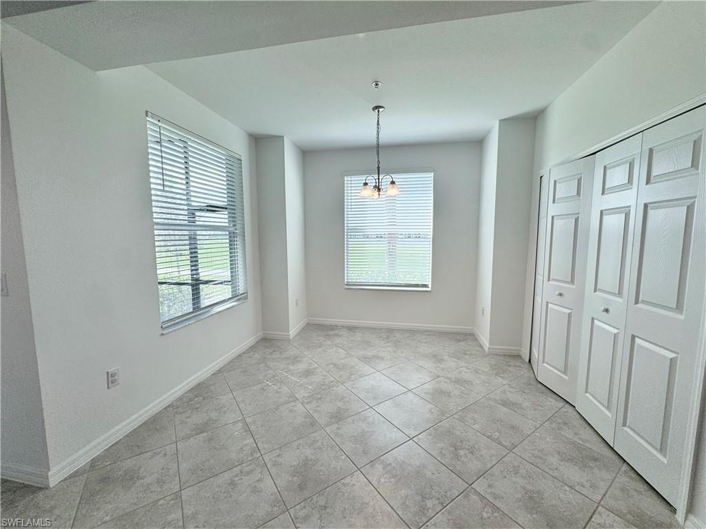 15970 Grassland Lane, Unit 2813 Babcock Ranch, FL 33982 - Photo 13 of 39 Unfurnished dining area featuring a notable chandelier and light tile patterned floors