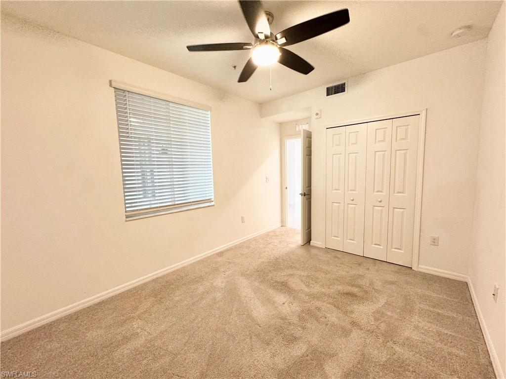 15970 Grassland Lane, Unit 2813 Babcock Ranch, FL 33982 - Photo 4 of 39 Unfurnished bedroom featuring light carpet, a closet, and ceiling fan