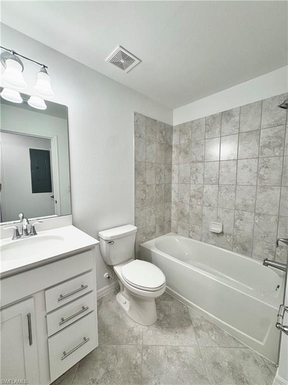 15970 Grassland Lane, Unit 2813 Babcock Ranch, FL 33982 - Photo 5 of 39 Full bathroom featuring tiled shower / bath combo, tile patterned floors, electric panel, toilet, and vanity