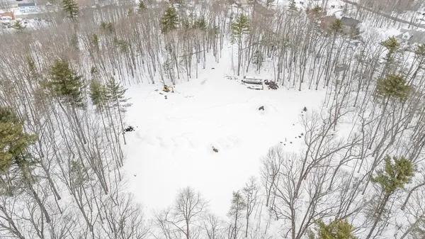 a view of roof covered with snow in front of house