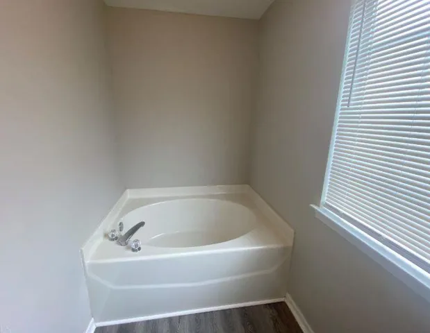 a white bath tub sitting in a bathroom