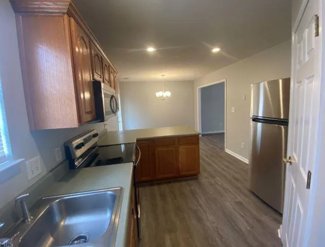 a kitchen with stainless steel appliances a refrigerator and a stove