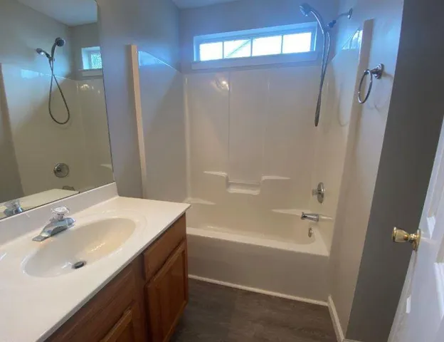 a bathroom with a sink a shower and a mirror