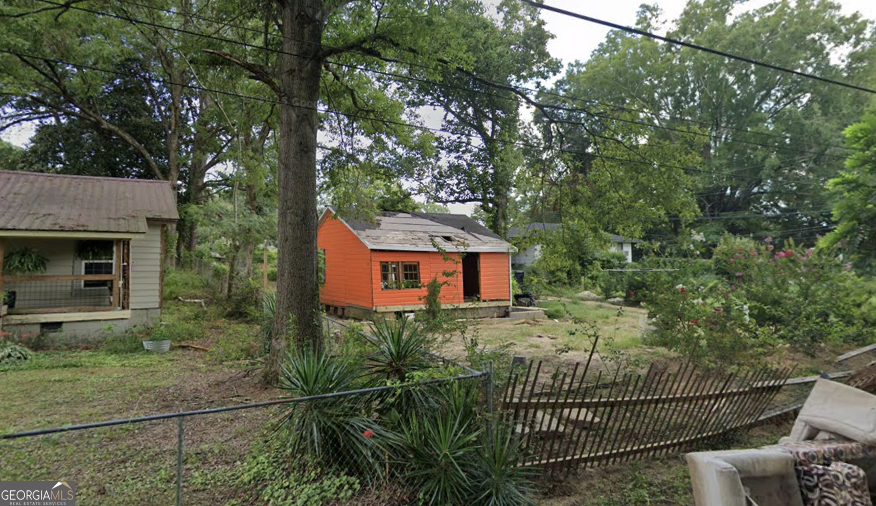 101 Broad Street Summerville, GA 30747 - Photo 4 of 6 a view of a house with a small yard and wooden fence