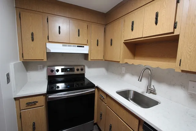 a kitchen with stainless steel appliances a refrigerator sink and cabinets