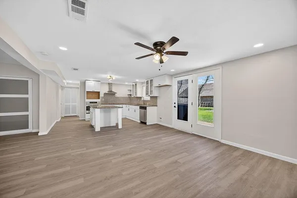 a view of a kitchen with a sink a kitchen a refrigerator and a window