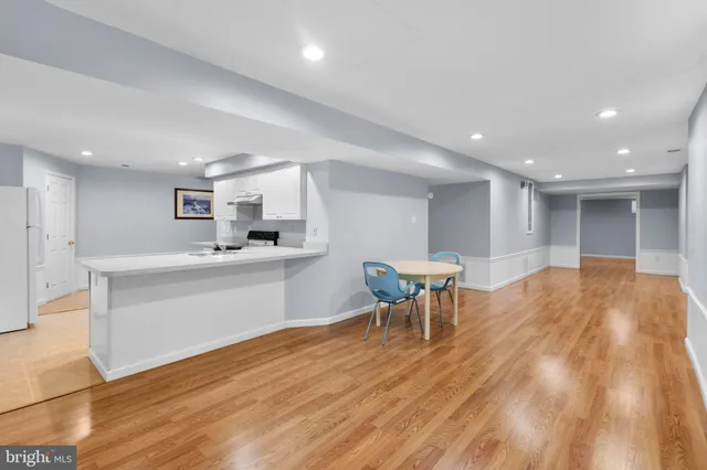 a kitchen with a sink cabinets and wooden floor