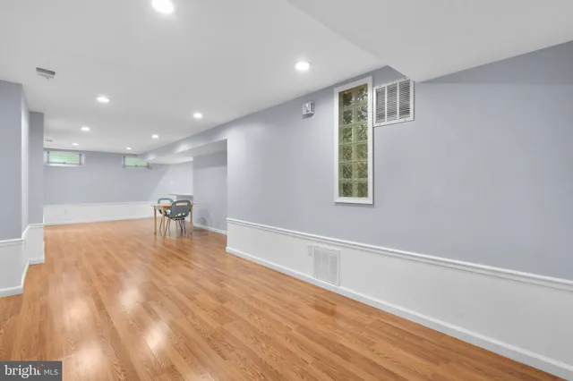 a view of a livingroom with a furniture wooden floor and a window