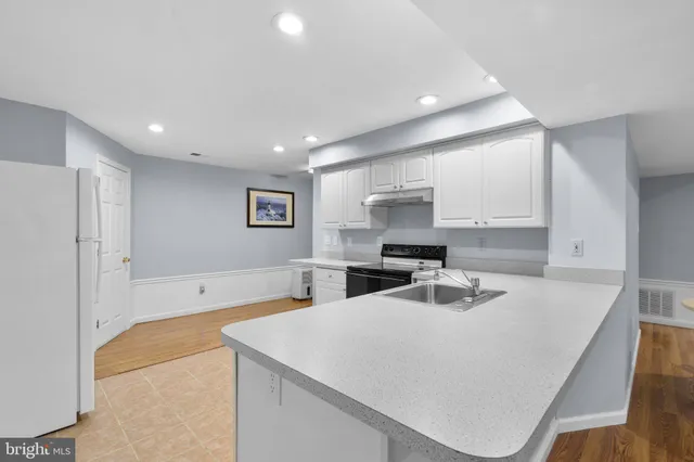 a kitchen with a sink a stove and refrigerator