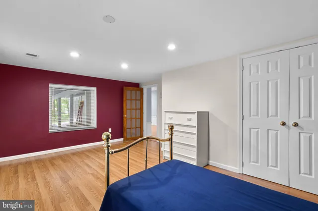 a big room with wooden floor windows and closet