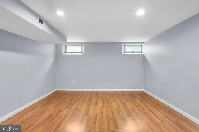 a view of a room with wooden floor and white walls