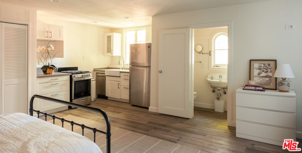 488 St Pierre Road Los Angeles, CA 90077 - Photo 11 of 12 a view of a kitchen with fridge and workspace