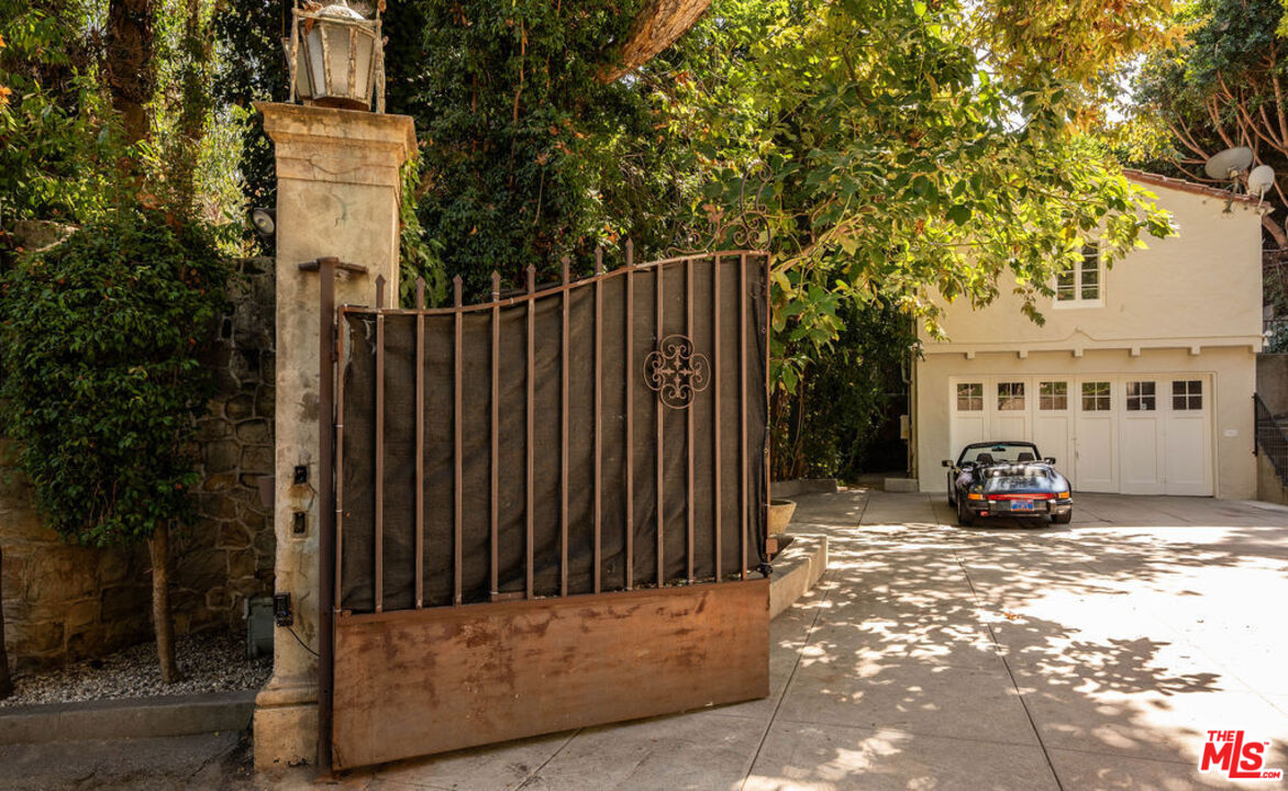 488 St Pierre Road Los Angeles, CA 90077 - Photo 12 of 12 a view of a brick house with many windows next to a road