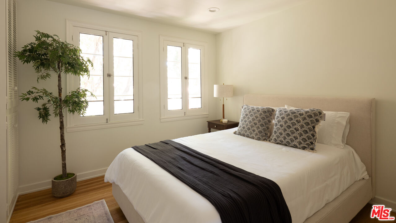 488 St Pierre Road Los Angeles, CA 90077 - Photo 6 of 12 a bedroom with a bed and a window