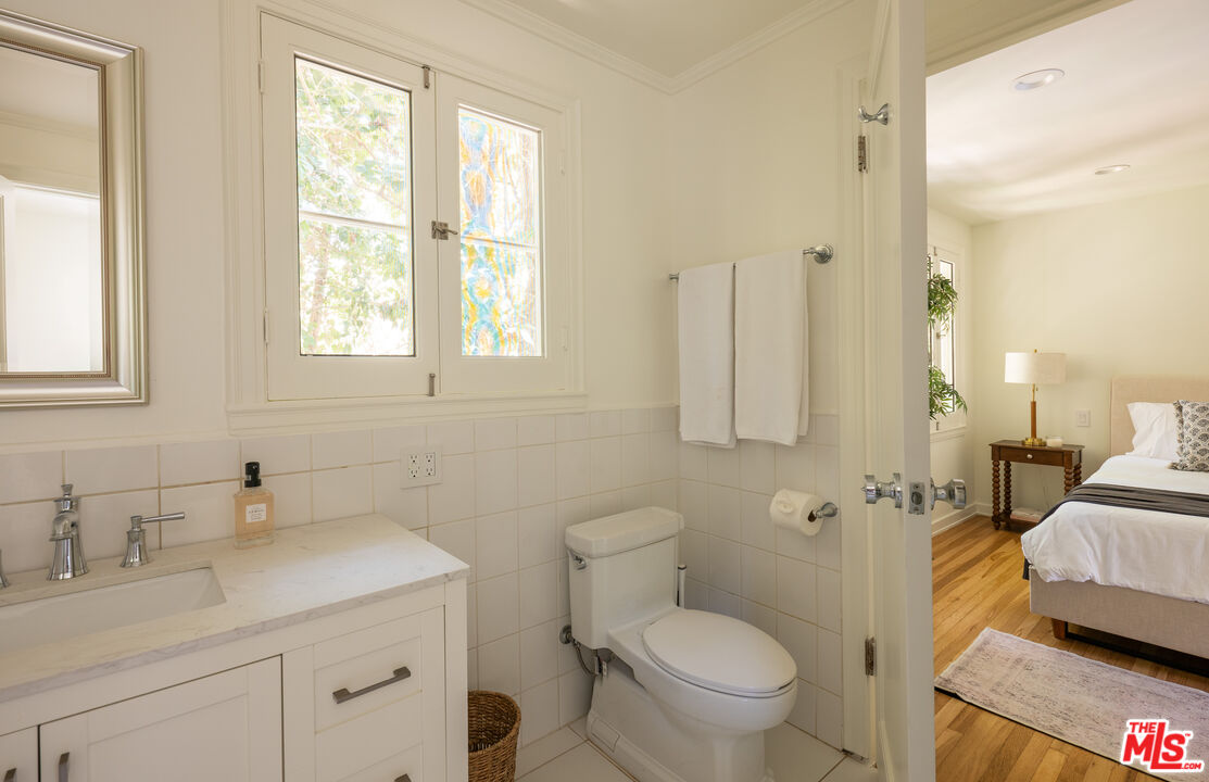 488 St Pierre Road Los Angeles, CA 90077 - Photo 7 of 12 a bathroom with a granite countertop sink toilet and shower