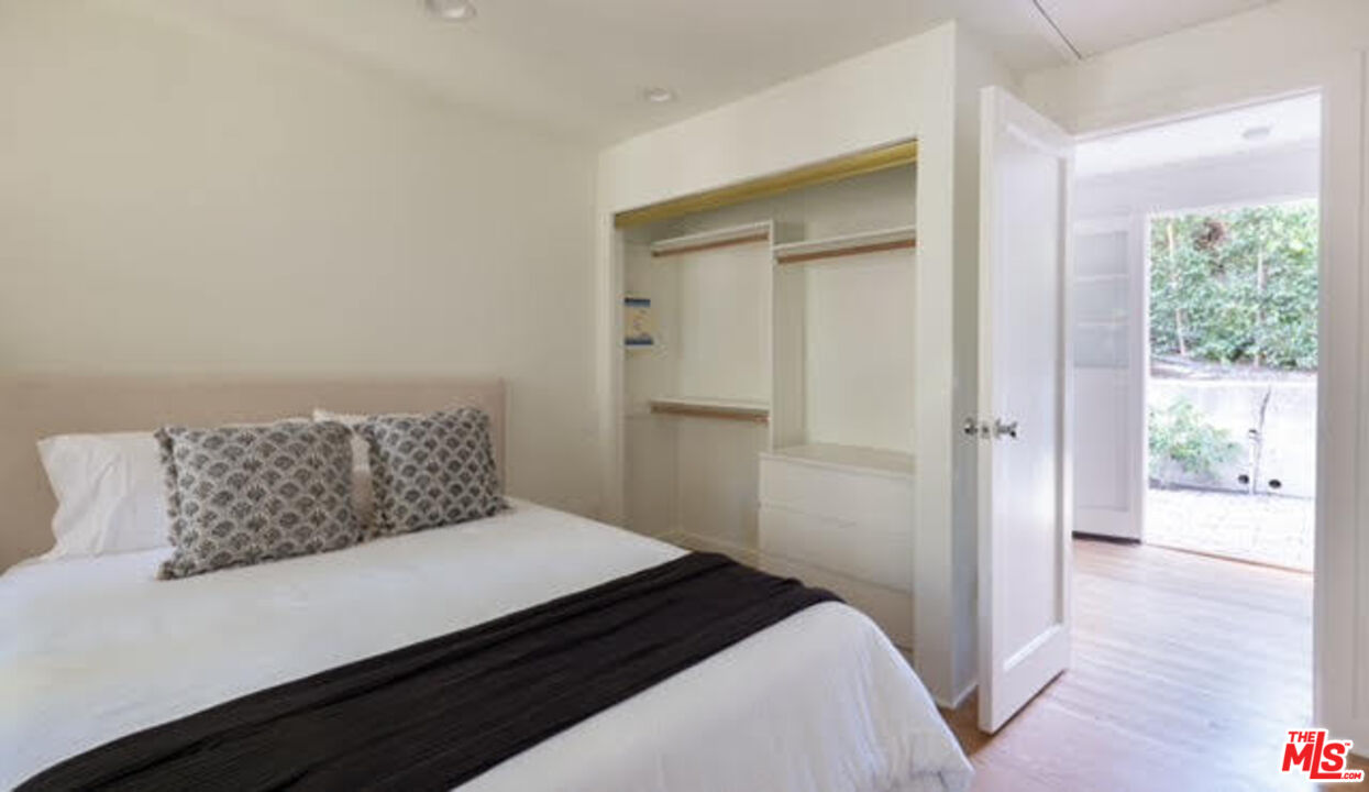 488 St Pierre Road Los Angeles, CA 90077 - Photo 9 of 12 a bedroom with a bed and window