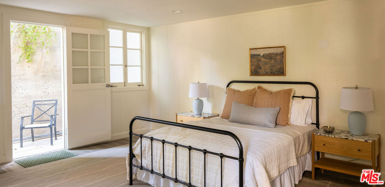 488 St Pierre Road Los Angeles, CA 90077 - Photo 10 of 12 a bedroom with a bed and a window