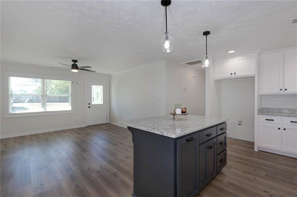 2899 Lamb Road Smiths Station, AL 36877 - Photo 6 of 26 Open-concept living area with wood-finish flooring, a ceiling fan, and a light-filtering window