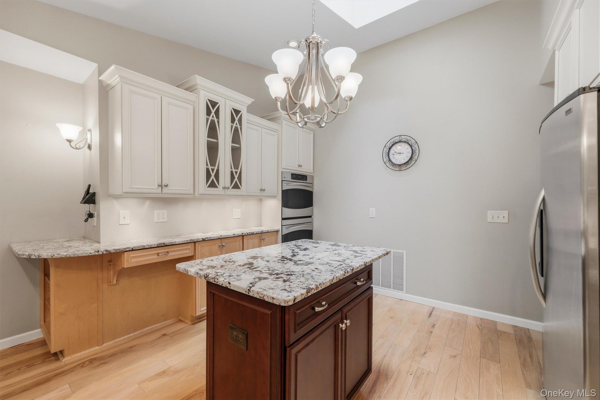 75 Pleasant Ridge Drive Poughkeepsie, NY 12603 - Photo 14 of 47 Custom kitchen with center island and snack bar, stainless appliances including double ovens, granite counters and wood floors