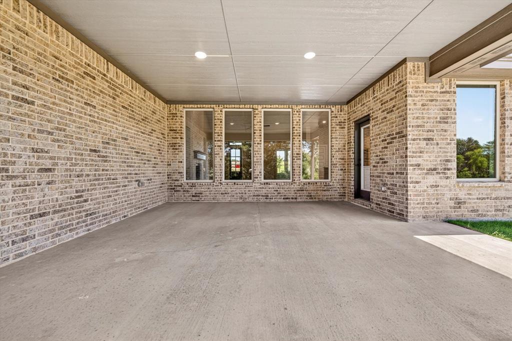 409 Mcalpine Springtown, TX 76082 - Photo 33 of 38 Covered patio featuring a light-toned brick facade and recessed lighting