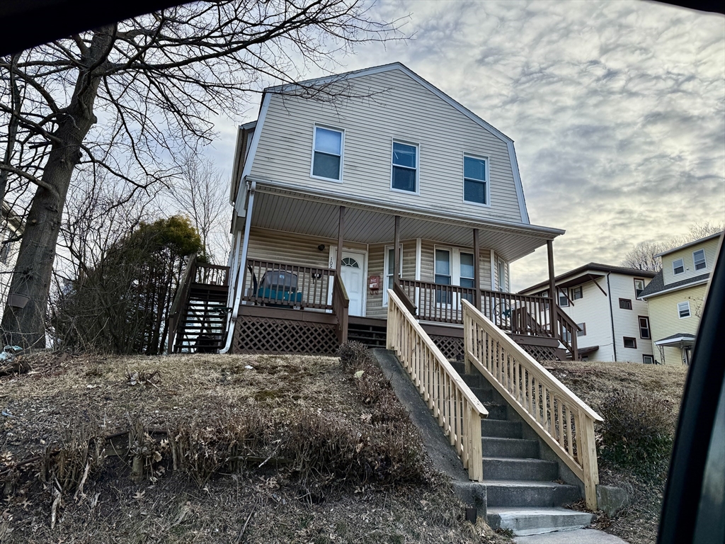 102 Hamilton Street Worcester, MA 01604 - Photo 1 of 3 a view of a house with wooden fence and a tree
