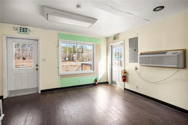 a view of a room with wooden floor and windows