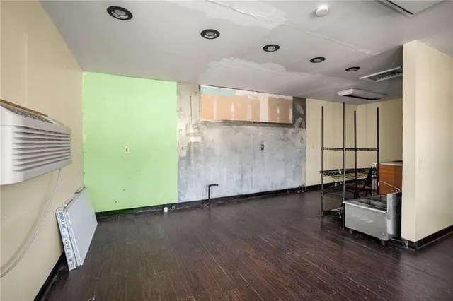 a view of a room with wooden floor and windows