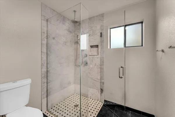 a white bath tub sitting next to a toilet