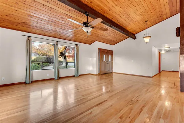 a view of room with window and wooden floor