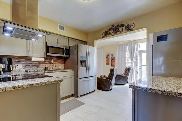 a kitchen with stainless steel appliances granite countertop a sink and cabinets