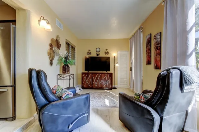a living room with furniture fireplace and chair