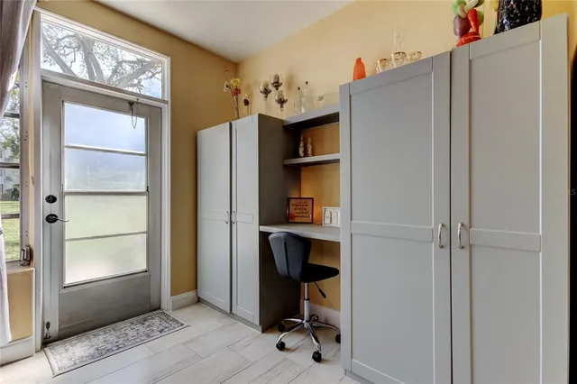 a view of a backyard with plants and a table and chair