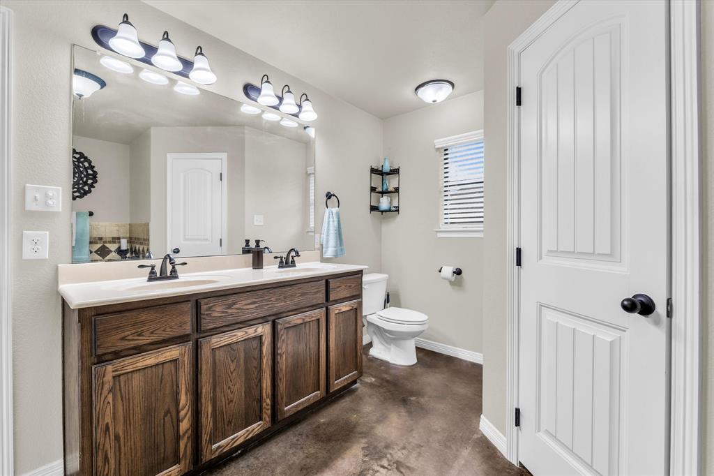 814 Springdale Circle Lorena, TX 76655 - Photo 27 of 37 Bathroom featuring a double vanity with wood-finish cabinetry and a light-colored countertop