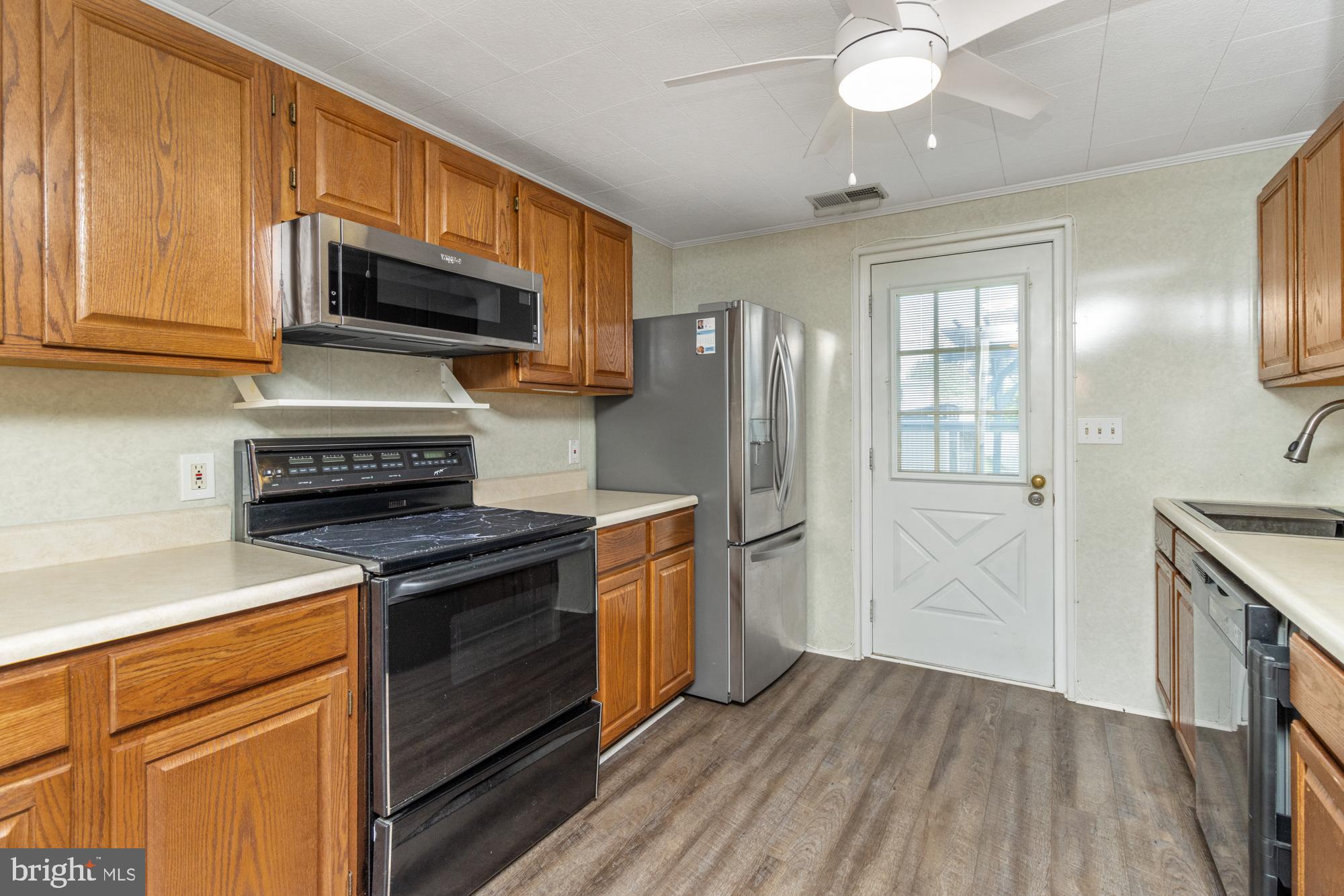 3135 Sollers Point Road Baltimore, MD 21222 - Photo 11 of 36 a kitchen with stainless steel appliances granite countertop a stove a refrigerator and a microwave