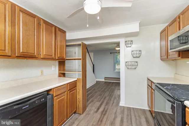 a kitchen with granite countertop wooden cabinets a sink and dishwasher