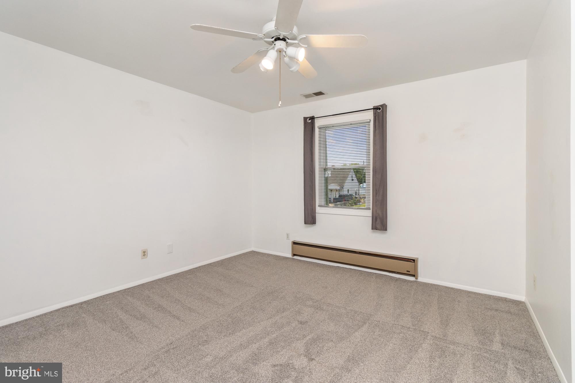 3135 Sollers Point Road Baltimore, MD 21222 - Photo 19 of 36 an empty room with a window and ceiling fan