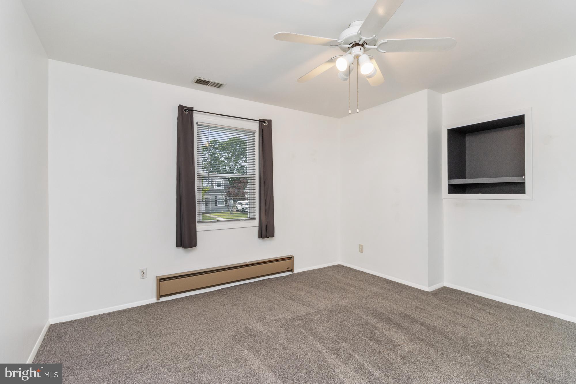 3135 Sollers Point Road Baltimore, MD 21222 - Photo 20 of 36 a view of an empty room with window and a ceiling fan