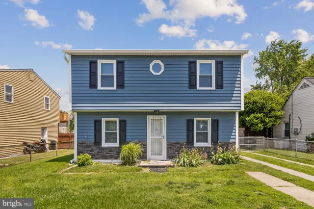 a backyard of a house with yard and outdoor seating