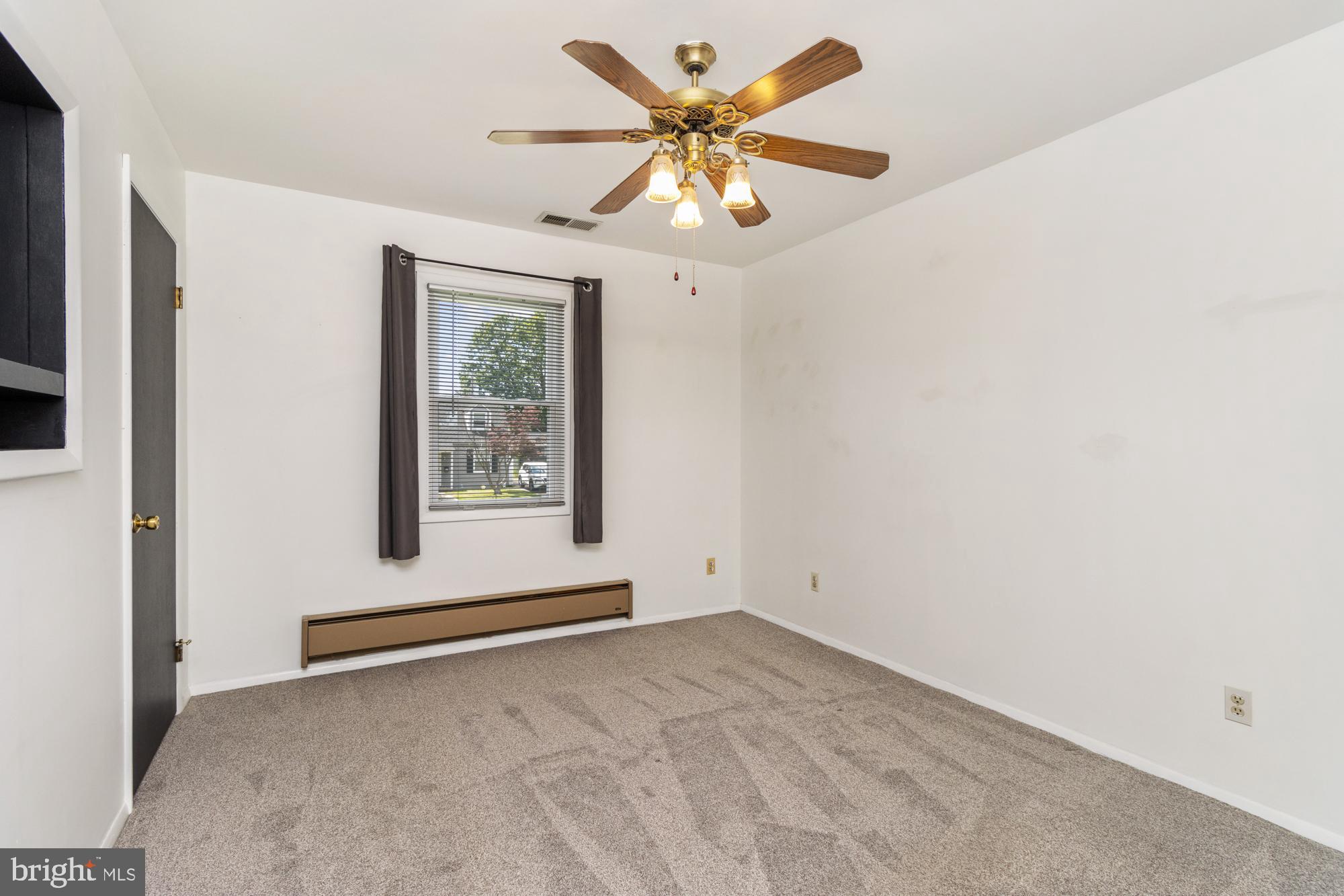 3135 Sollers Point Road Baltimore, MD 21222 - Photo 22 of 36 an empty room with a window and a ceiling fan